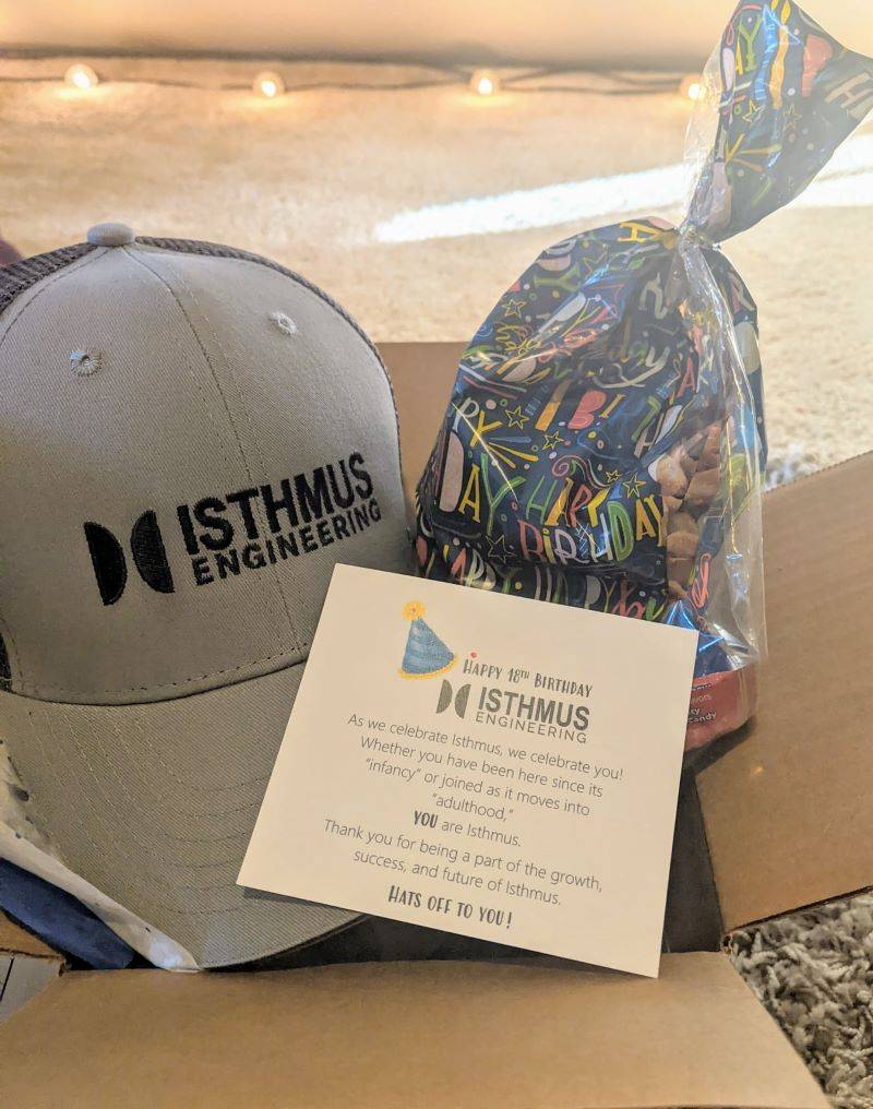 Gift box with gray Isthmus Engineering hat, card, and small bag of treats